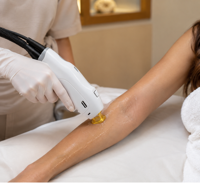 Practitioner treating a client's forearm with a GentleMax Pro Plus laser system